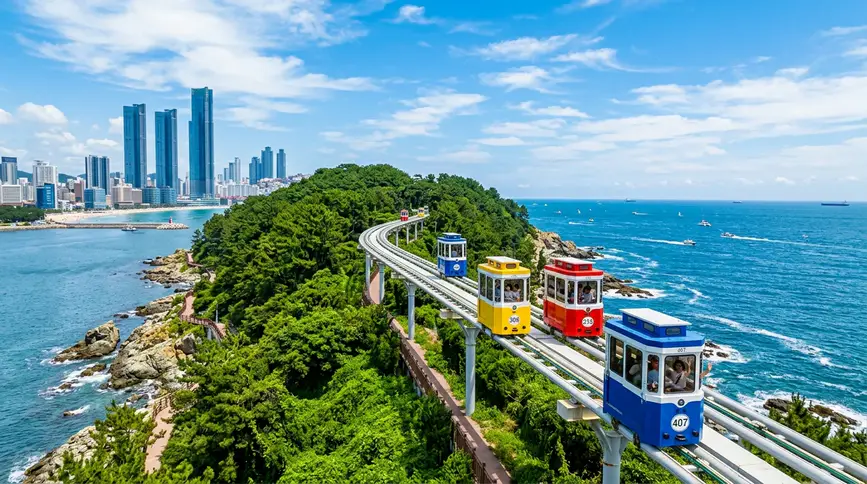 Colorful vintage-style capsules traveling on elevated rail along sparkling blue sea and rocky coastline